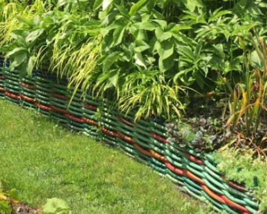 Tired of stone retaining walls? How about a wall of woven hoses. Hold onto those broken leftovers.