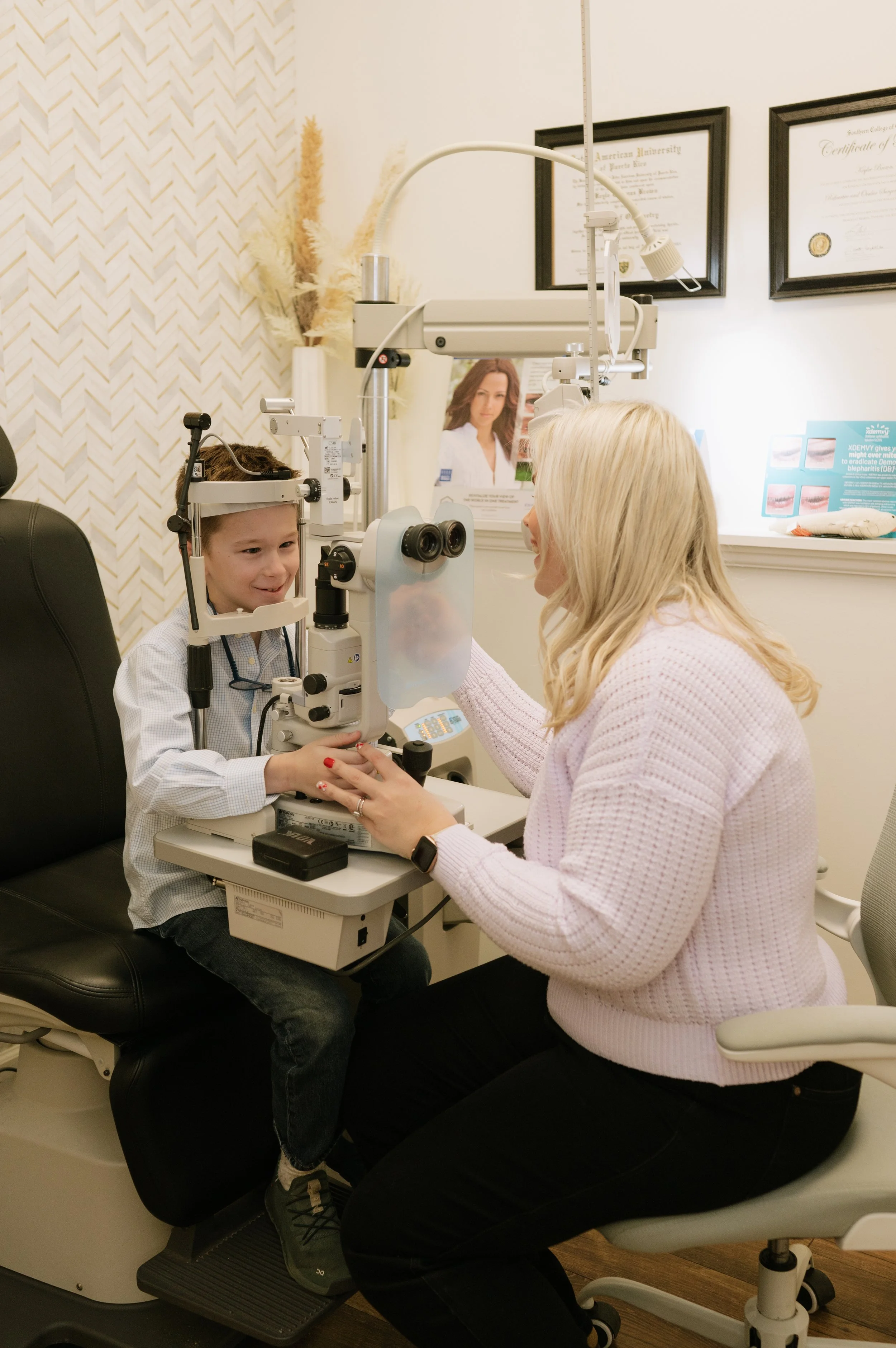 A boy getting an eye exam from an optometrist in an eye care clinic.