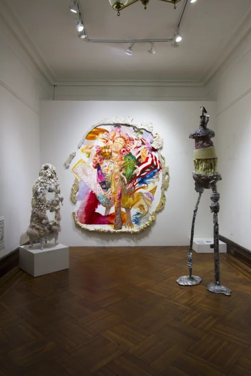 Sculpture on right: Daniel Giordano, Study for Brother (MY Invaluable Non-Player Character) , 82 x 28 x 15”, aluminum, glazed ceramic, pigment, glitter, wood, construction adhesive insole, Orange Tang, Nesquik Strawberry powder, limestone, epoxy resin, epoxy paste, urethane, oil-based clay, oil stick, acrylic, enamel, fibered aluminum coating, 23 karat red gold, bald eagle excrement, Canadian currency, self-tanning lotion, foundation, artificial teeth, 2018 Painting: Andrew Woolbright, Shrinebeast Ecology , 84 x 90”oil and acrylic on canvas, carved plaster frames, 2018