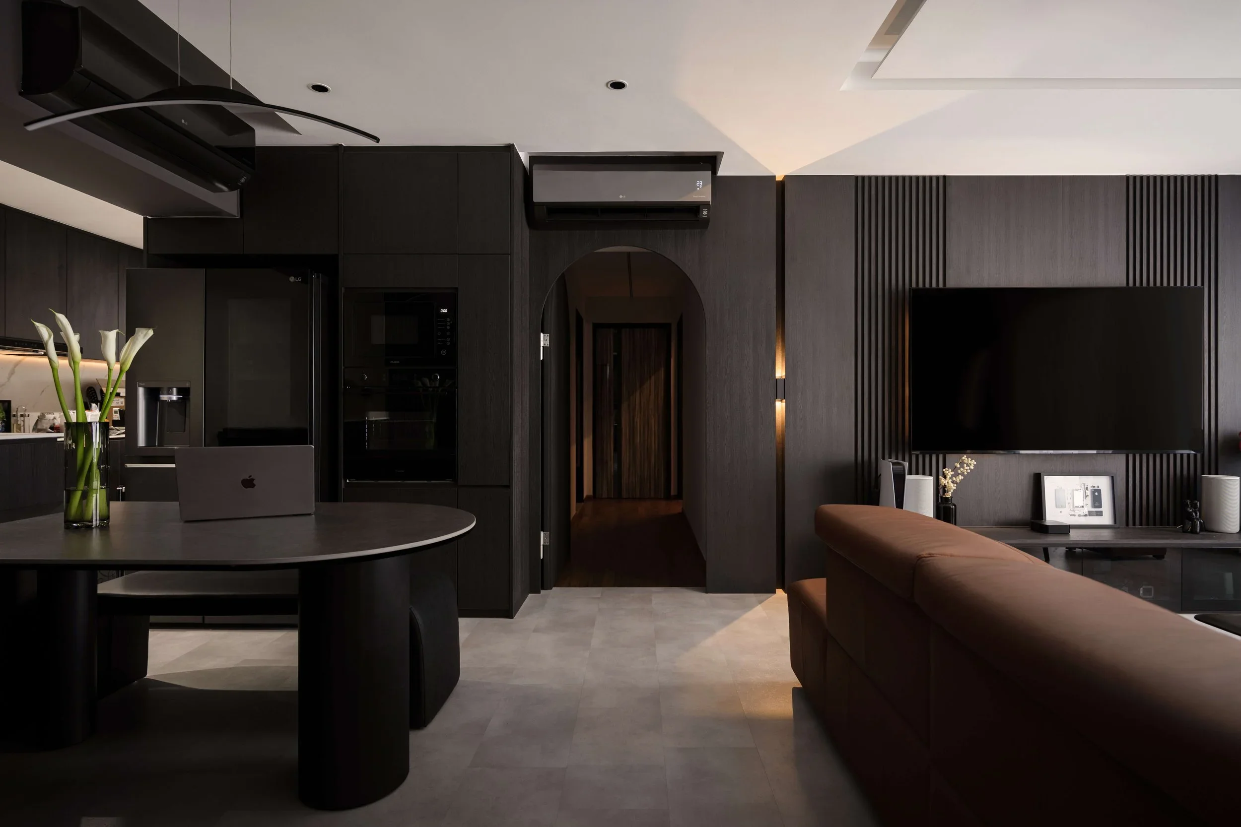 condo-interior-design-dark-open-kitchen-living-space.webp