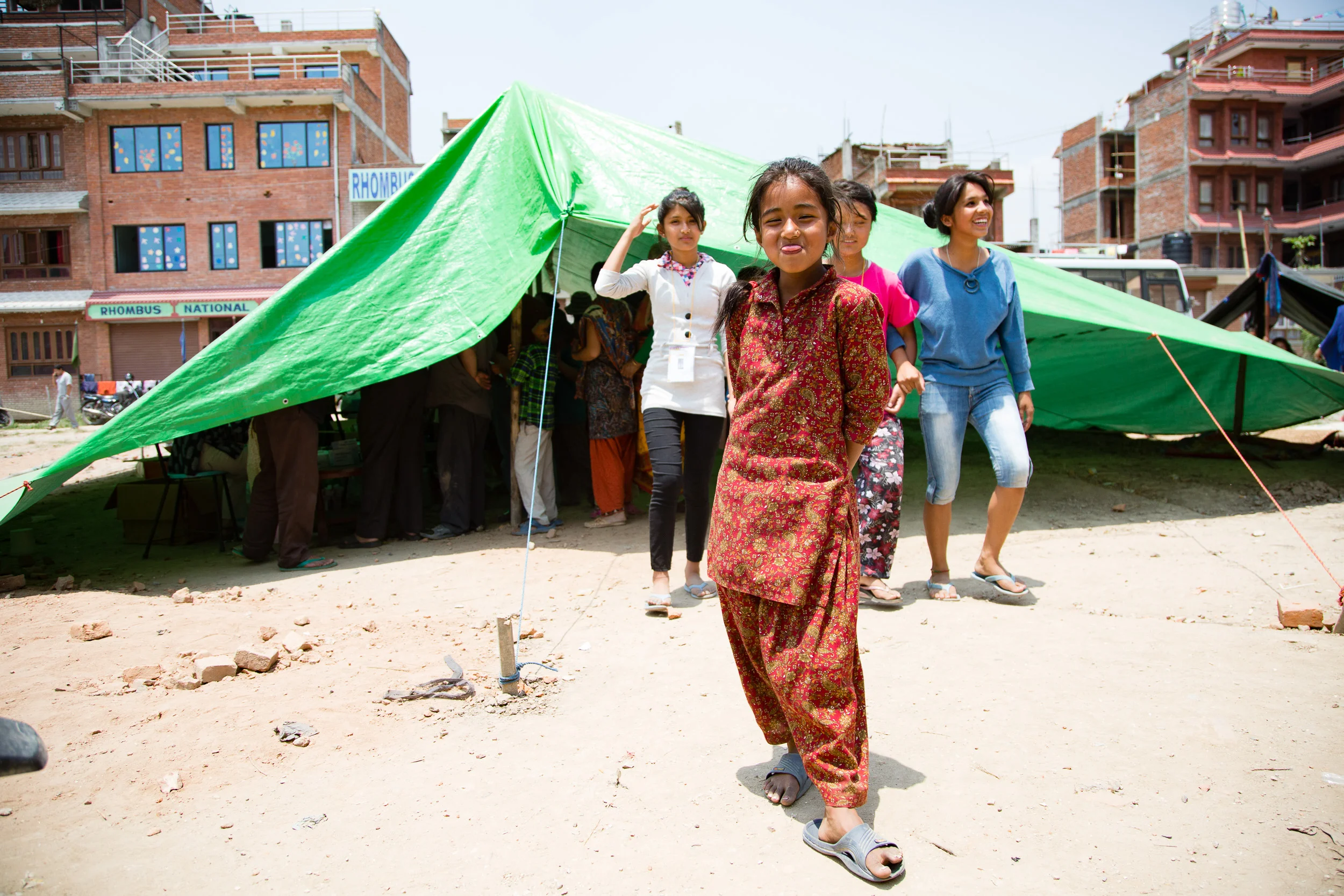 Even while waiting to see a doctor at an impromptu clinic set up in seriously earthquake damaged Bhakatpur this girl retains her sense of humor sticking her tongue out at me.