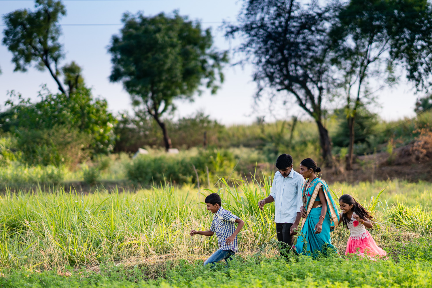 Young family walking on their small farm.