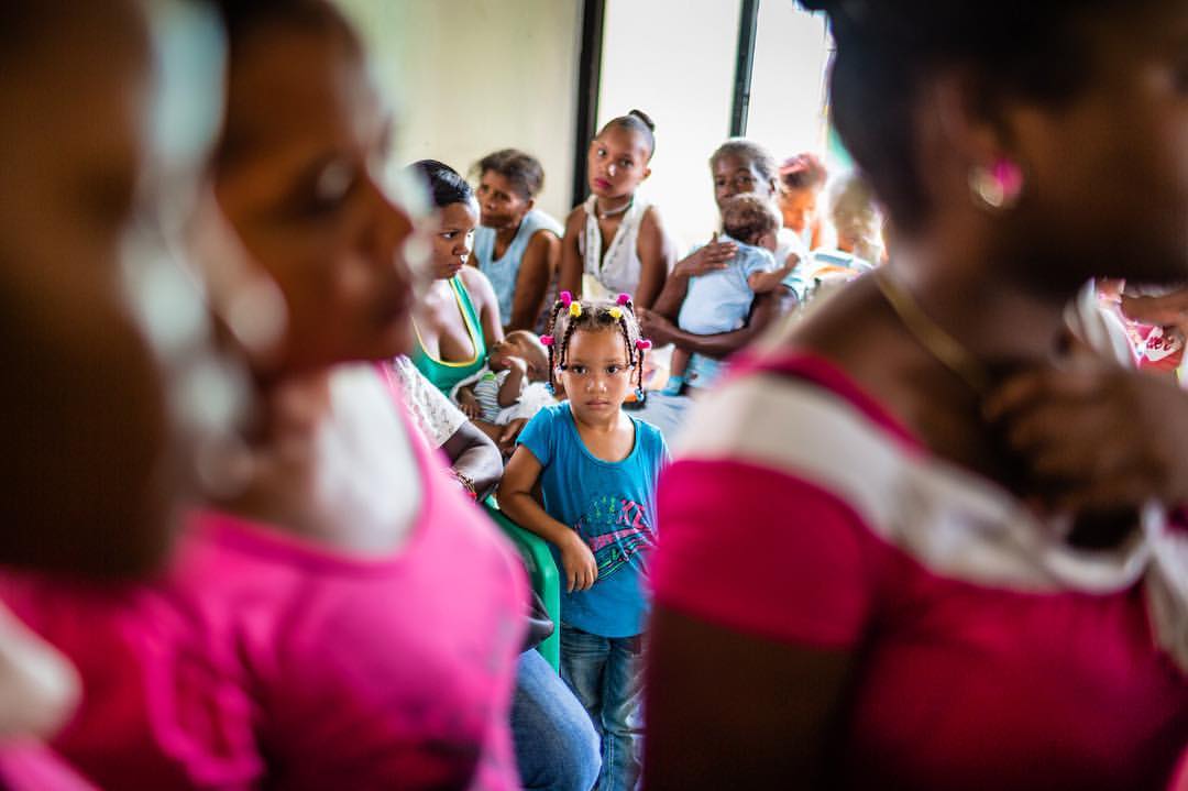 In many of the places I work in I stand out. Blending into the background, and being present when I choose to is something I strive for. This little one wasn't going to let me blend in. She watched me like a hawk. Documenting emergency relief efforts by AbbVie and Direct Relief in the aftermath of hurricane Matthew in the Dominican Republic.