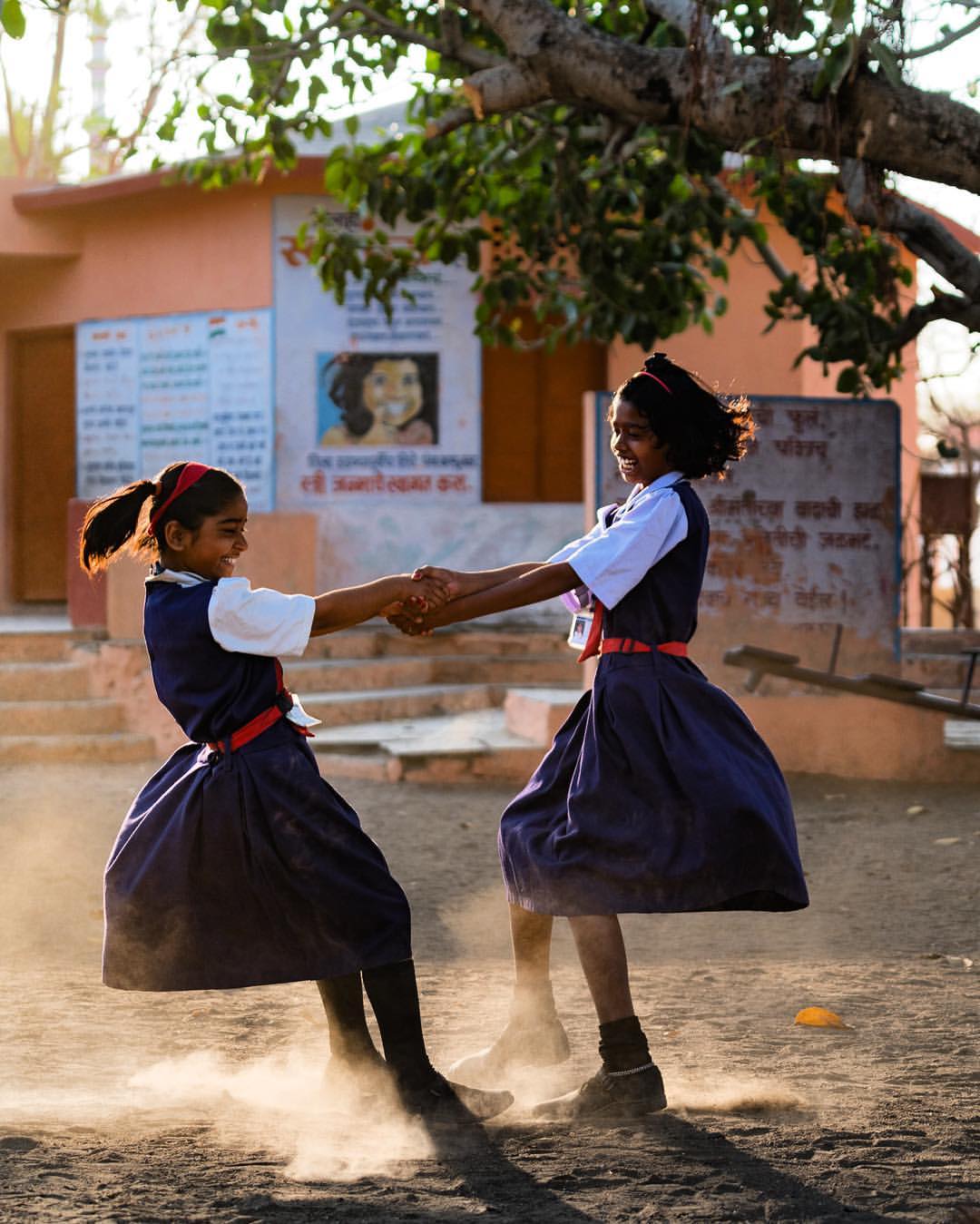I strive to create photographs that illustrate the joys of life no matter how mundane or small. School girls playing at recess captured while on assignment in India for Abbott