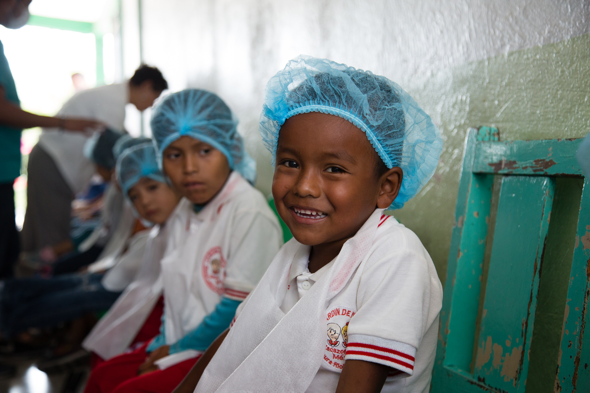 A boy waiting his turn to have his teeth checked at a free dental clinic in Mexico.