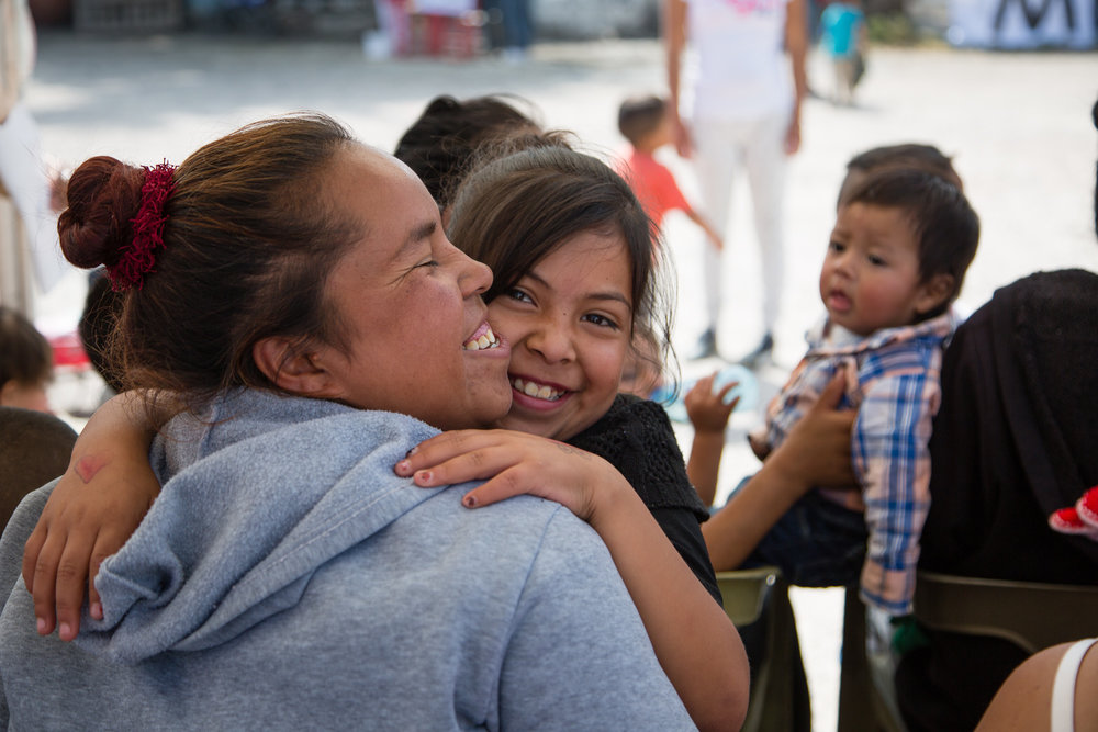 Mother and daughter waiting their turn at a temporary clinic outside of Mexico City.