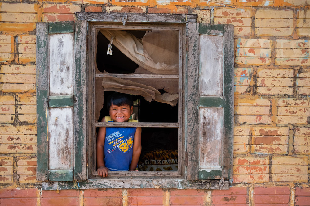 A little boy in the window of his home. El Chaco, Paraguay.