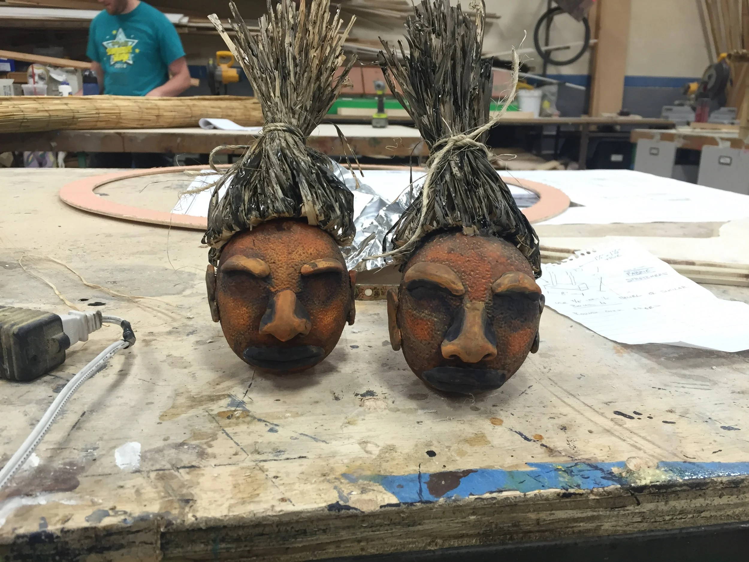 Billis's Orange Shrunken Heads for the Walnut Street Theater's Production of South Pacific . Made with fake fruit, sculpy, raffia, and acrylic paint.