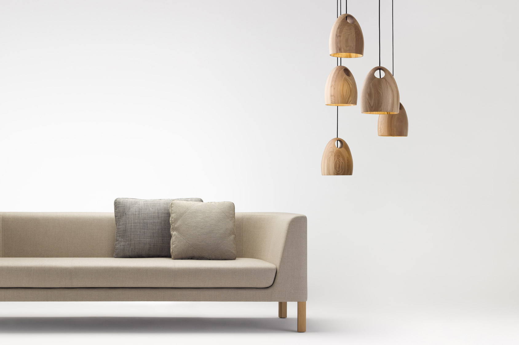 'Oak' Pendant by Ross Gardam with it's smooth lines creates a cosy feeling over a dining table