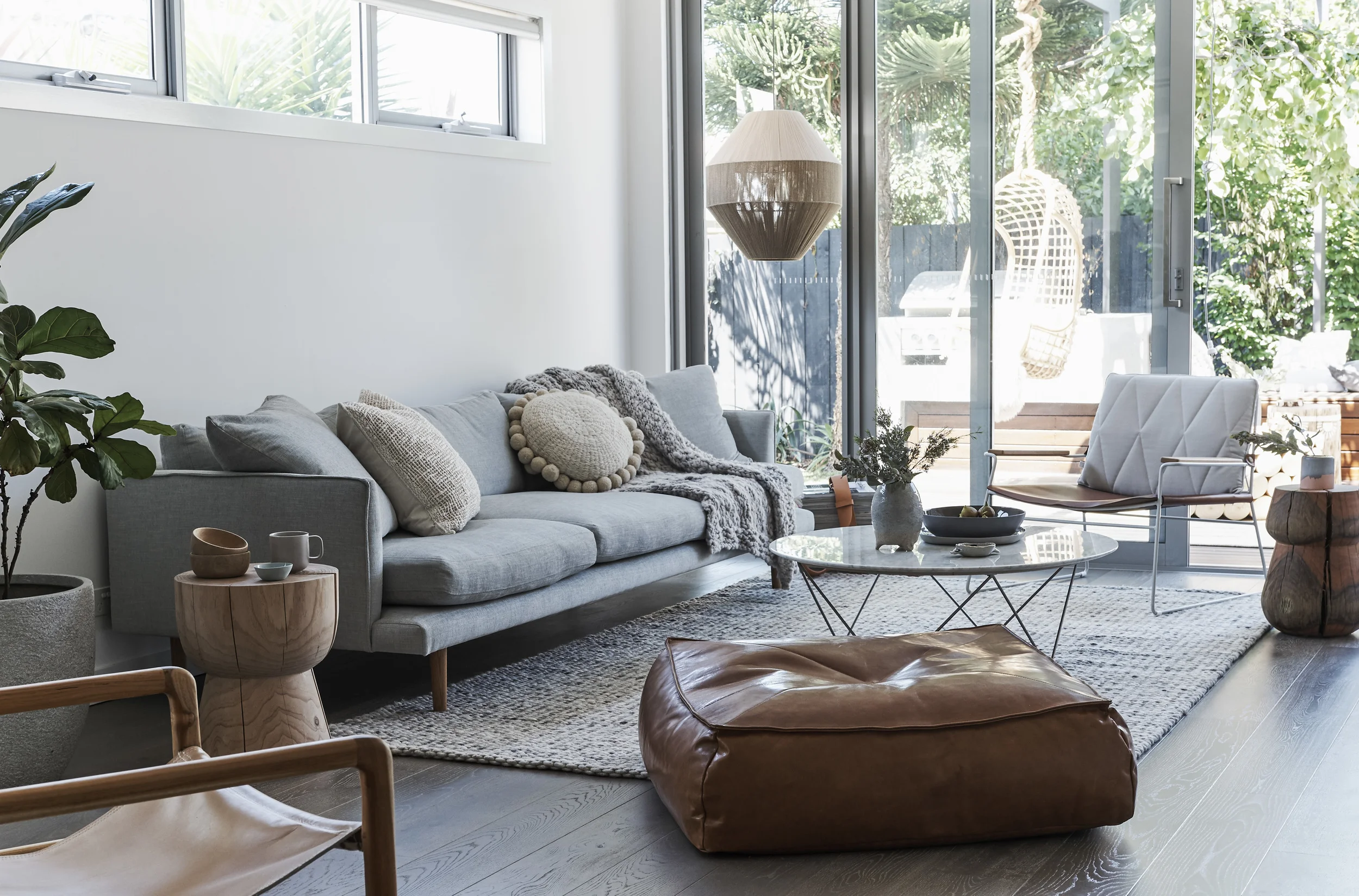 Natural timber is the hero in this warm, texural living space. Freddy Sofa Huset , Seb chair, Stanley stool and Alby ottoman Jardan , Egg cup stool Mark Tuckey , Como marble coffee table Globe West , Floor rug Halcyon Lake , Smith leather sling chair Barnaby Lane and ceramics by Bridget Bodneham and Marmouset Found . Dream weaver pendant light Pop and Scott , cushions We Are Pampa along with flame throw also by Tribe and Co .