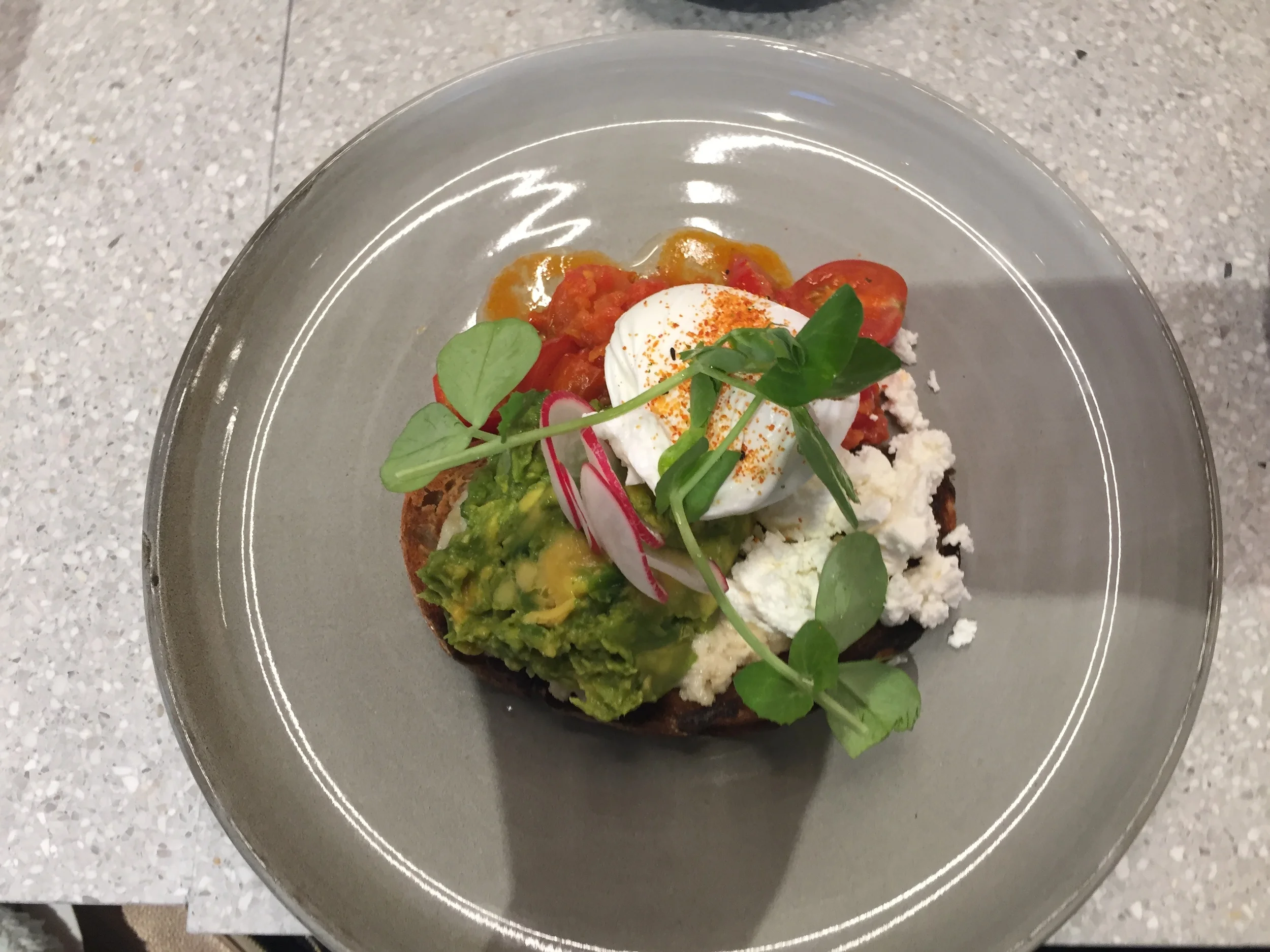 The smashed avocado on olive bread with poached egg, feta, radish and cheery tomatoes - AMAZING!