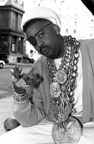 What J Cole meant by "Or you might be Slick Rick with 19 chains."