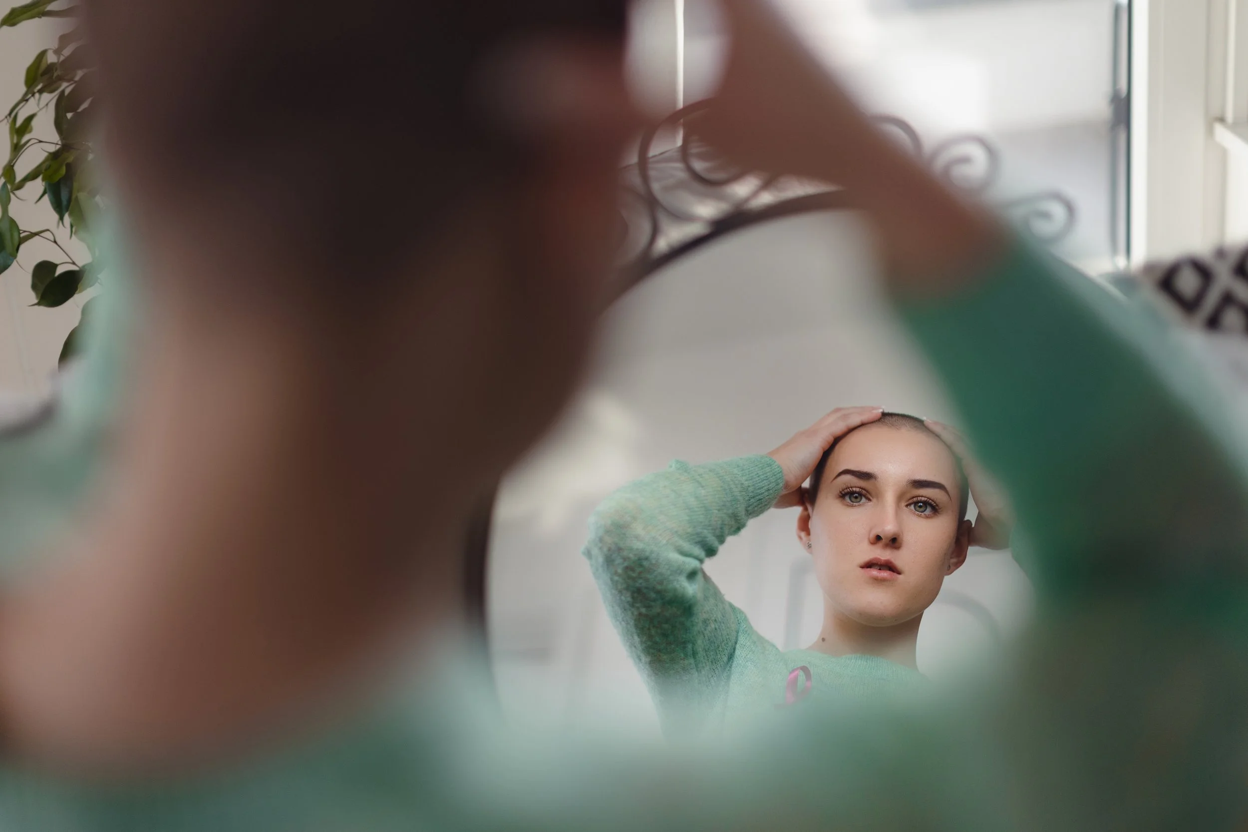 woman-looking-at-mirror-with-hands-on-head-2026-03-10-02-09-13-utc.jpeg