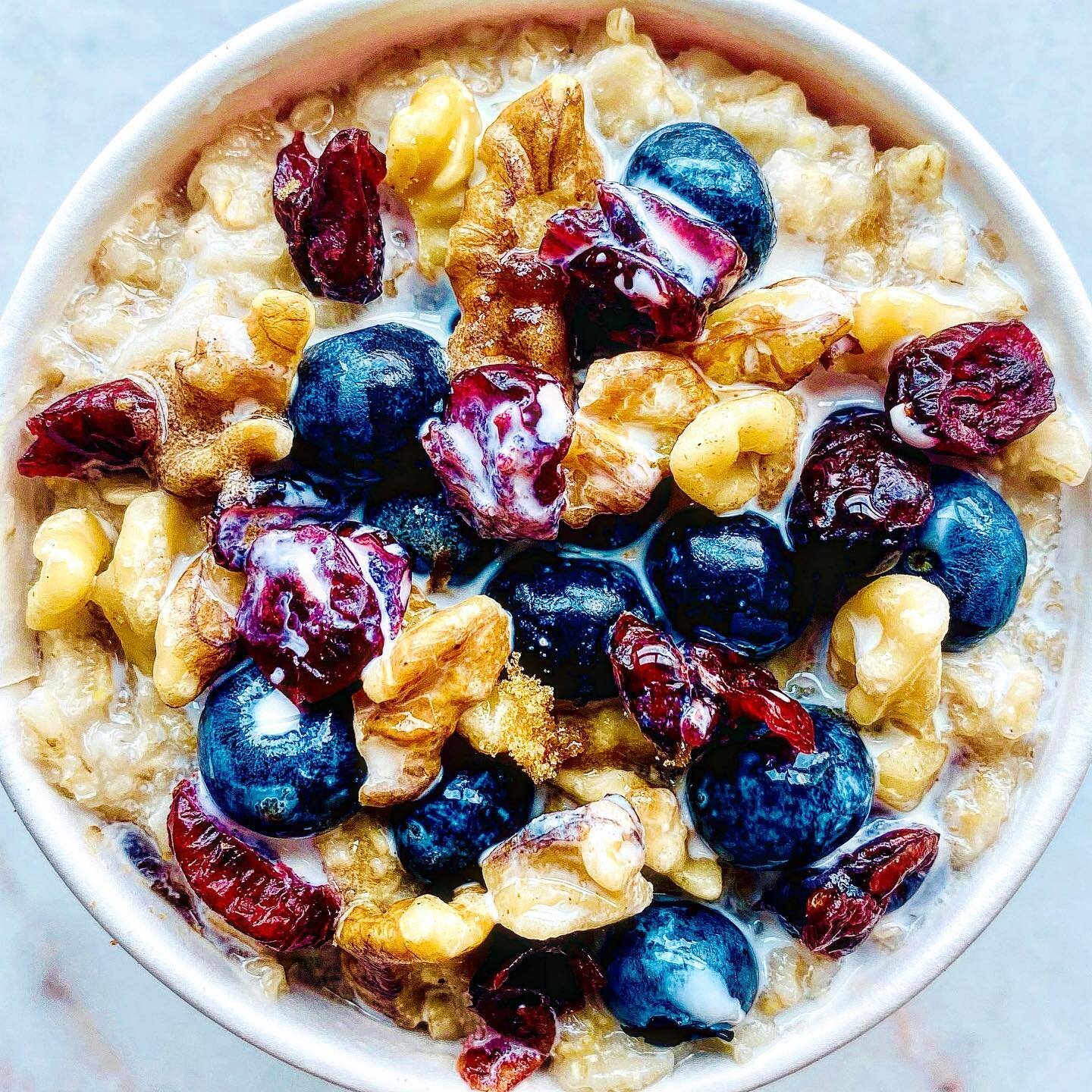 Waking up is hard to do! Especially with all this holiday socializing and late nights. After heavy, decadent dinners a comforting, simple, clean breakfast brings back life! 
Try topping your oats with this easy combo of fresh blueberries, dried cranb