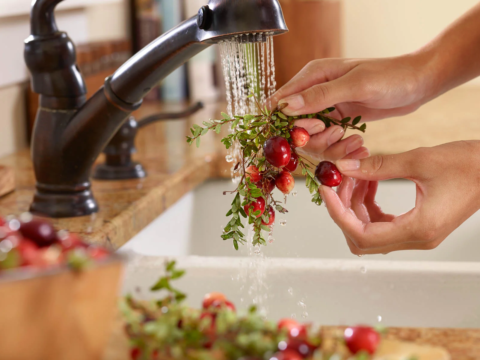 Cranberries being Washed in a Kitchen Sink