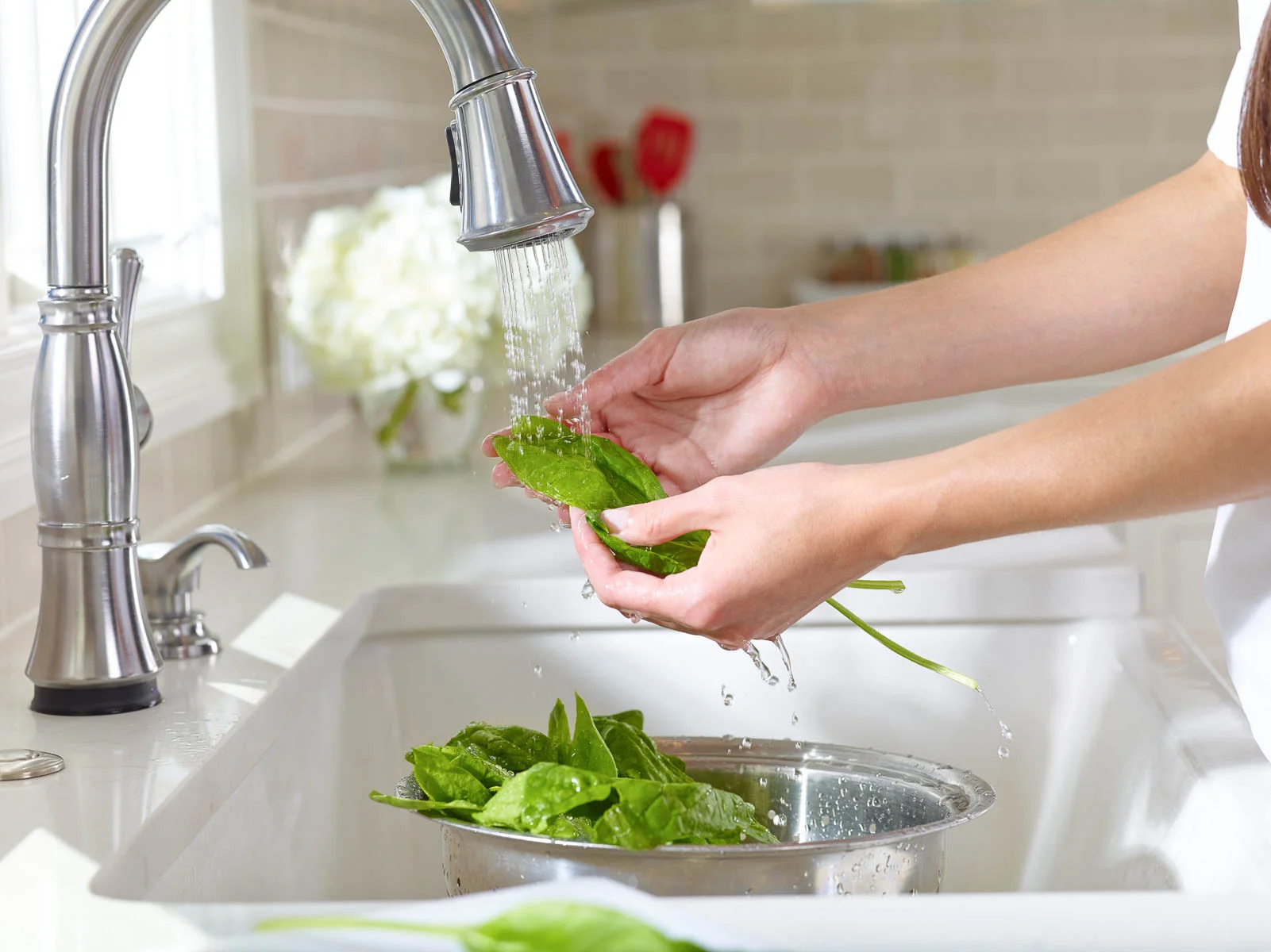 Salad being Rinsed in a Kitchen Sink