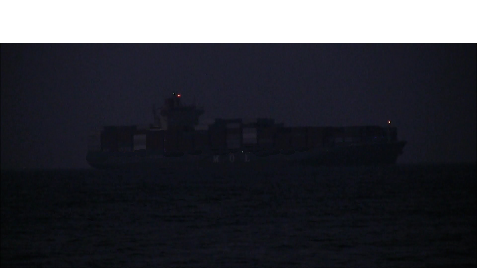 Container ships appearing out the dark