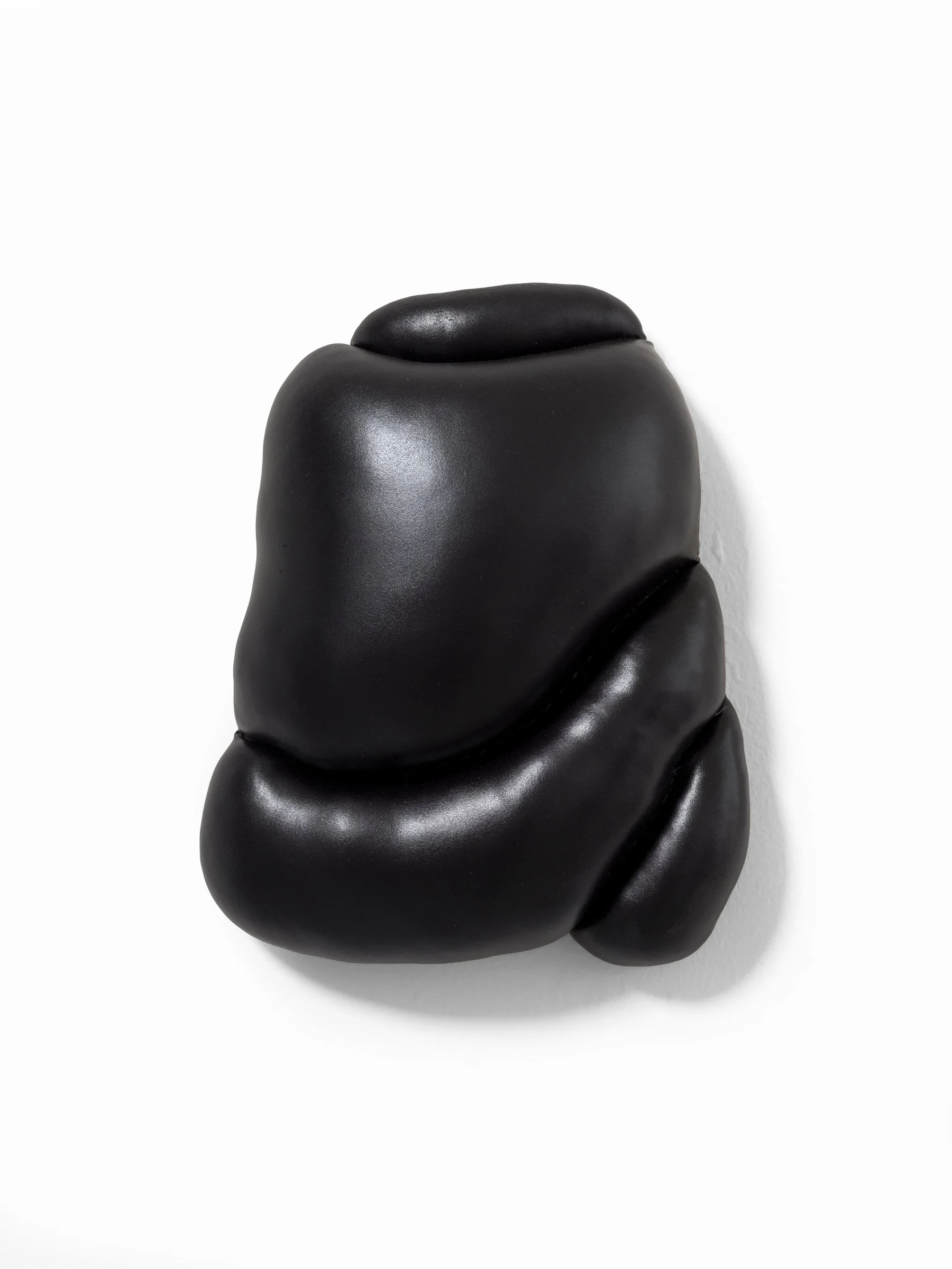 the force of darkness  2025 Fabric and stuffing on custom shaped wood panel. 13 x 11 x 4 in.