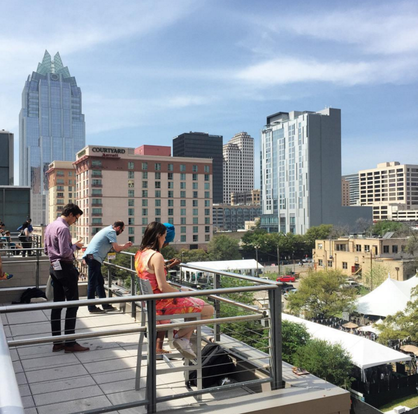 SXSW Interactive. Outside, on their phones. 
