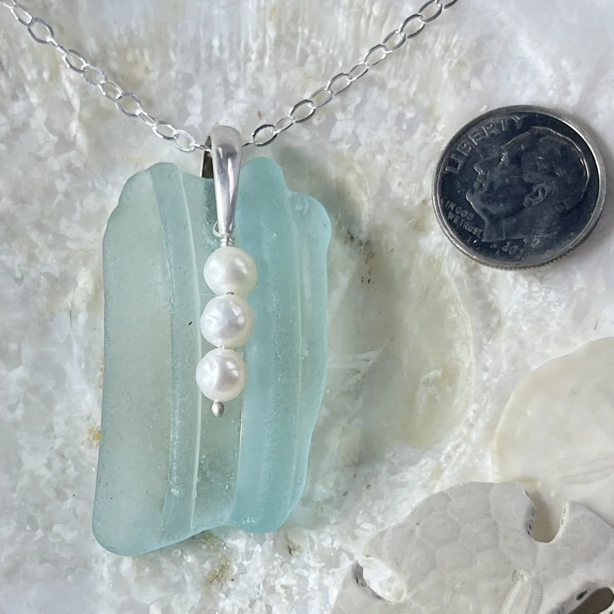 Blue seafoam sea glass necklace with a trio of freshwater pearls