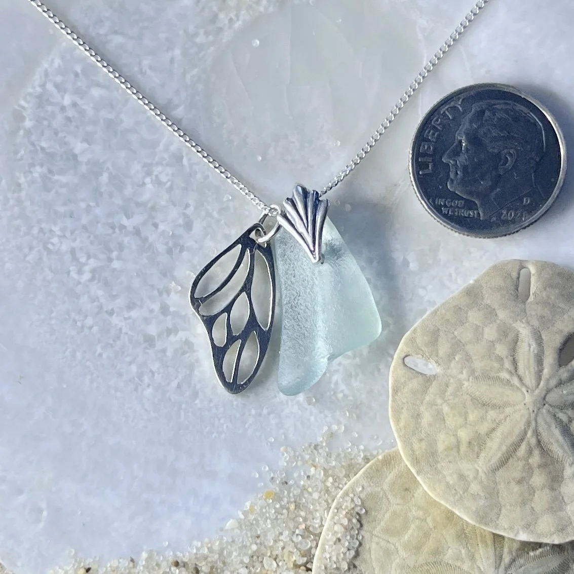Blue Seafoam Sea Glass Necklace with a Sterling Silver Butterfly Wing .jpg