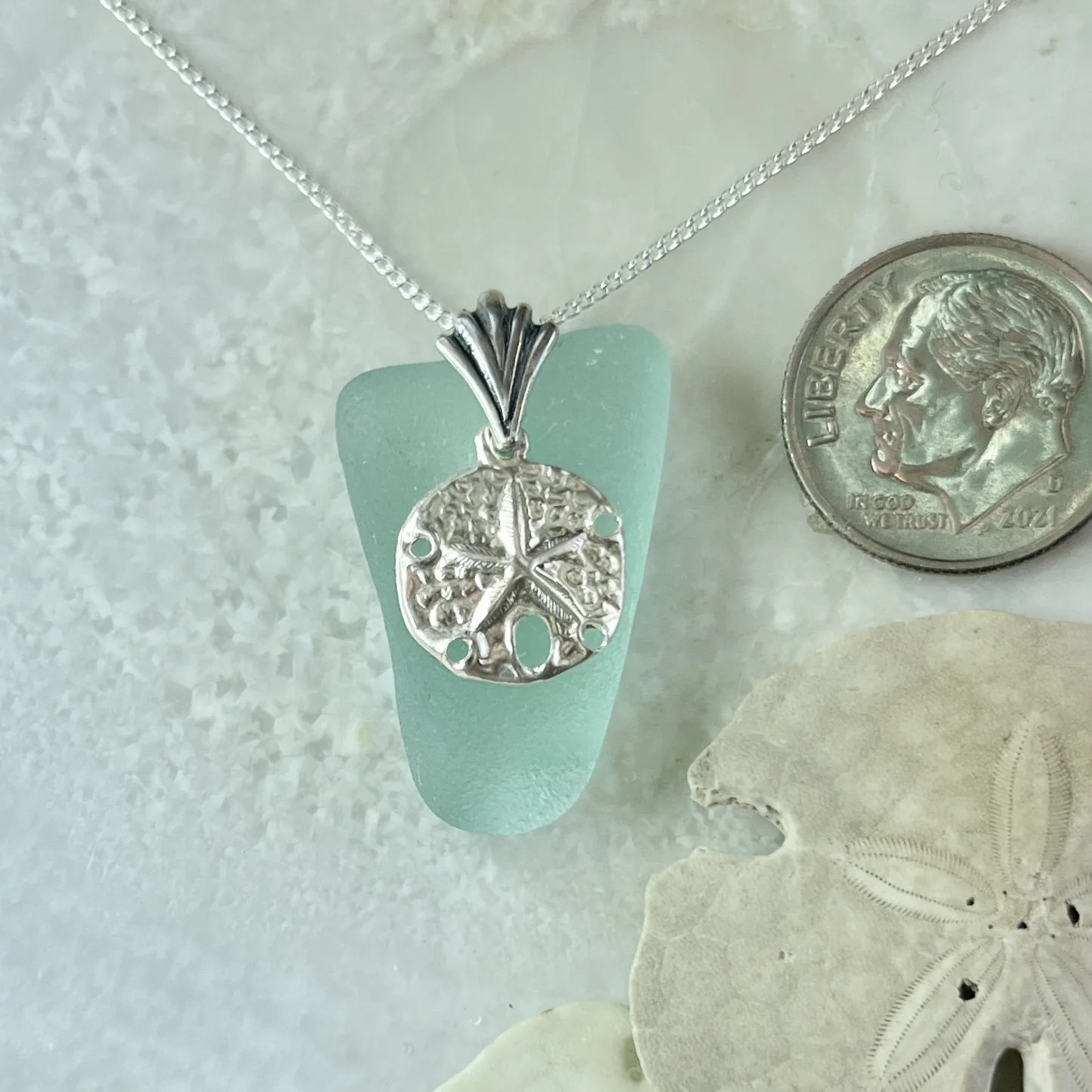 Blue Seafoam Sea Glass Necklace with a Sterling Silver Sand Dollar.jpg
