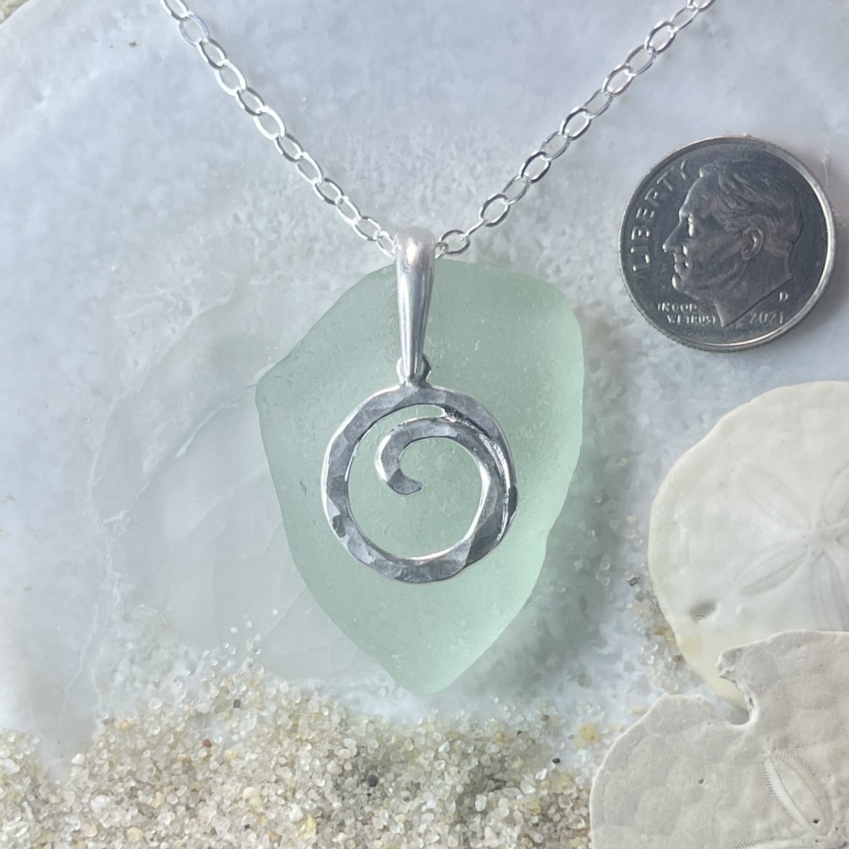 Seafoam sea glass necklace with a sterling silver ocean wave