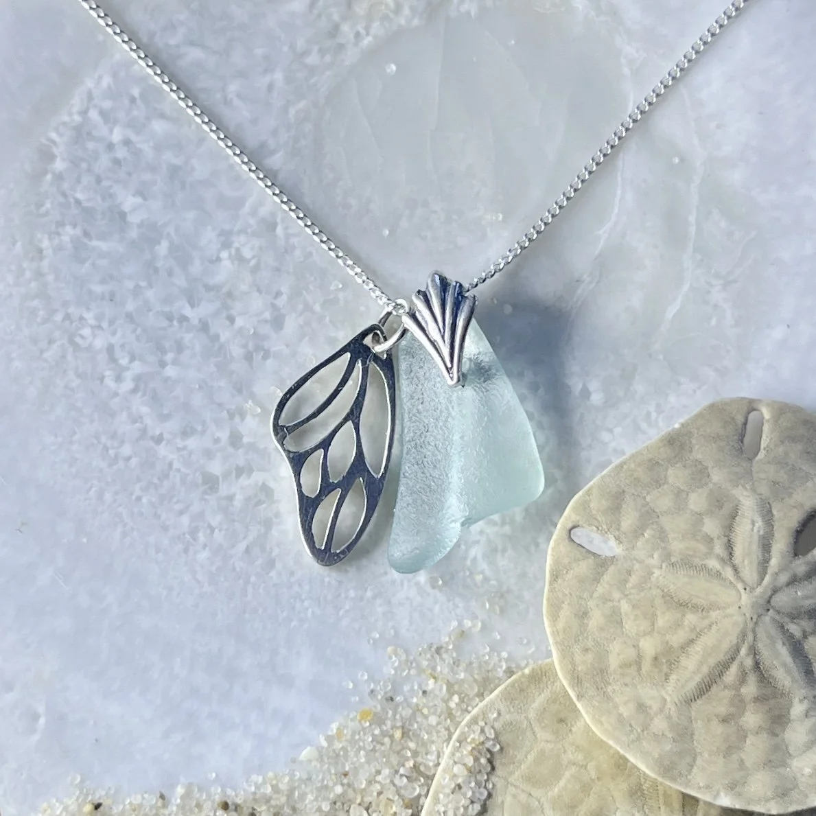 Blue Seafoam Sea Glass Necklace with a Sterling Silver Butterfly Wing .jpg