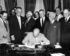 President Eisenhower signing HR7786, changing Armistice Day to Veterans Day. From left: Alvin J. King, Wayne Richards, Arthur J. Connell, John T. Nation, Edward Rees, Richard L. Trombla, Howard W. Watts