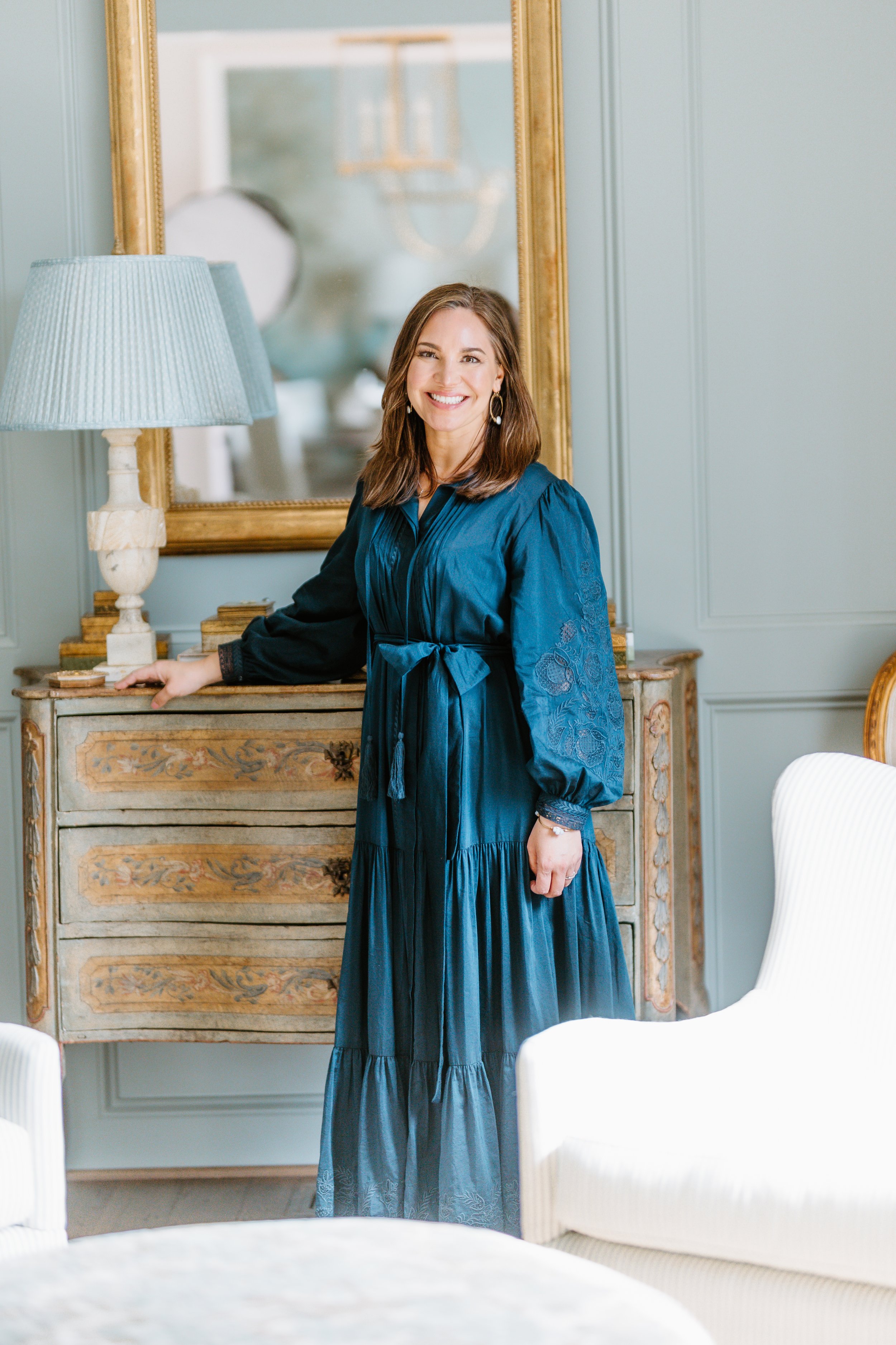 Tasha B Davis Interiors founder, Tasha Davis, Birmingham Interior Designer. Antique Chest, Alabaster Lamp, Paneled Wall. Mountain Brook, Alabama.