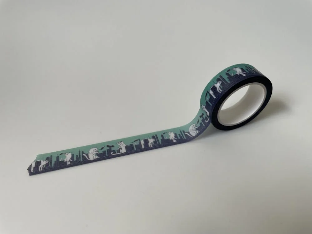 A roll of washi tape features giant cats destroying a city.
