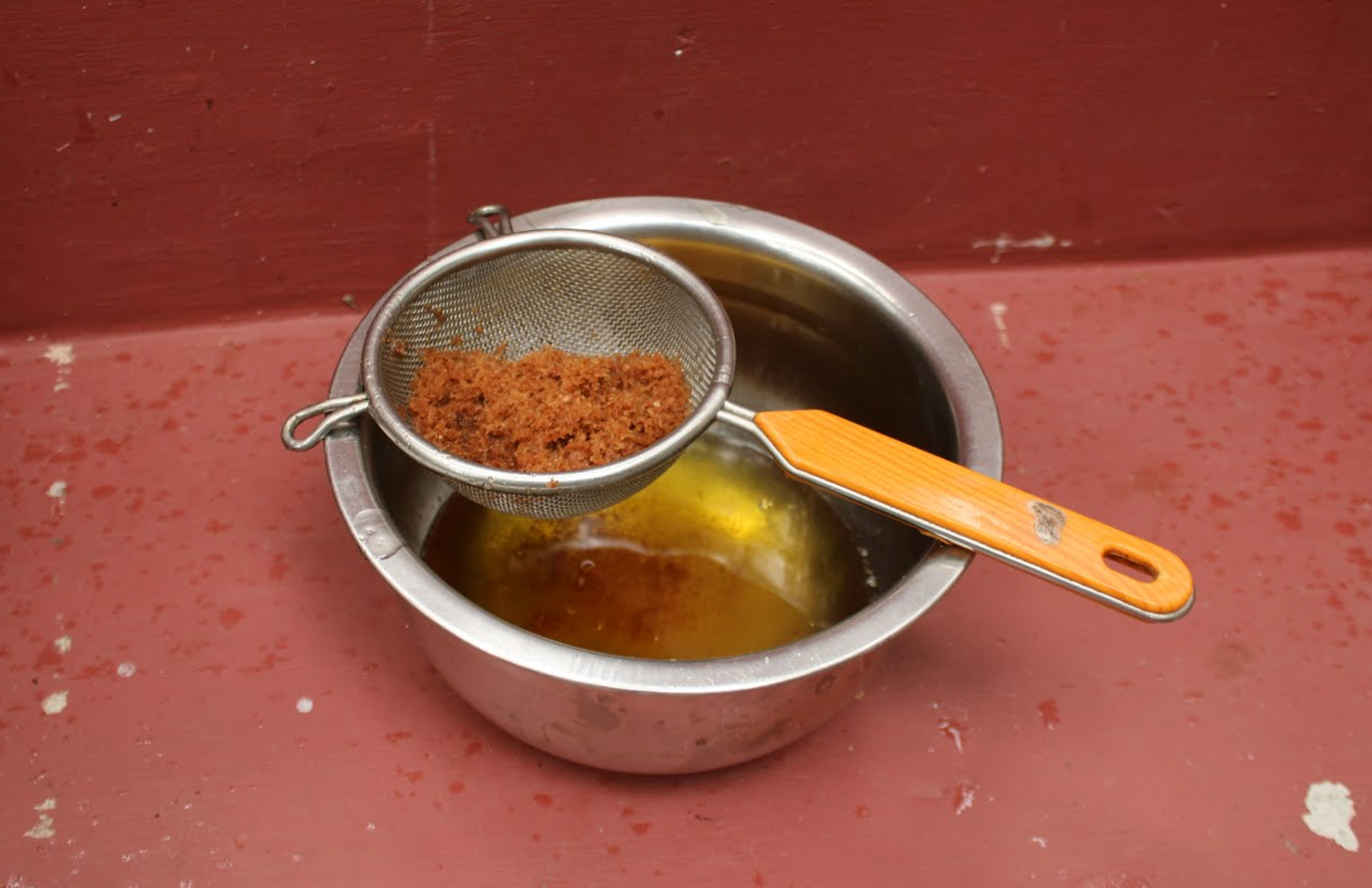 Filtering Ginger Massage oil, Kerala, India, via the Sivananda Yoga Vendanta Centre + Ashram
