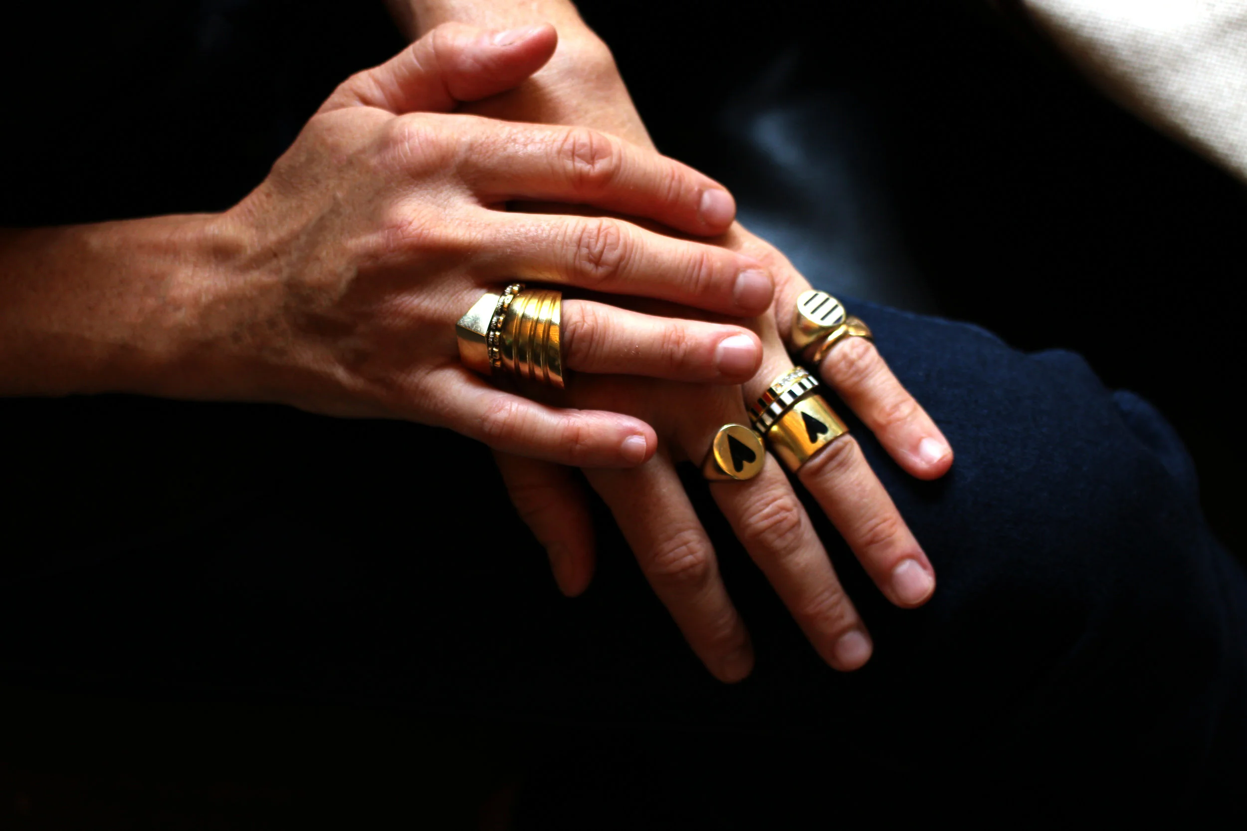 Stacks on stacks of Jessica Biales rings, including Heart and Stripe signets and bands, Honey ring, block signet and Mimosa rings.