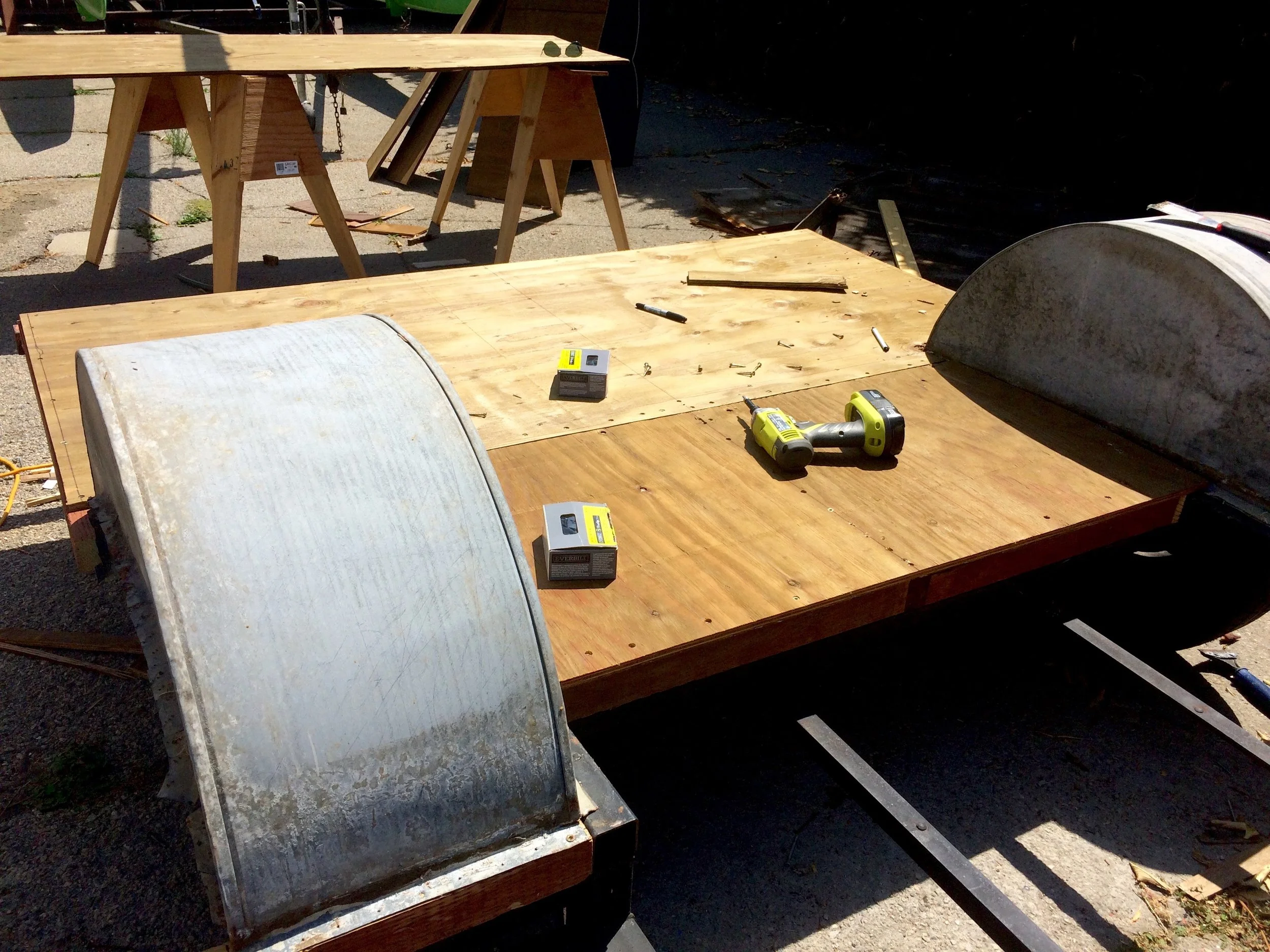 Attaching the plywood to the framing and wheel wells.