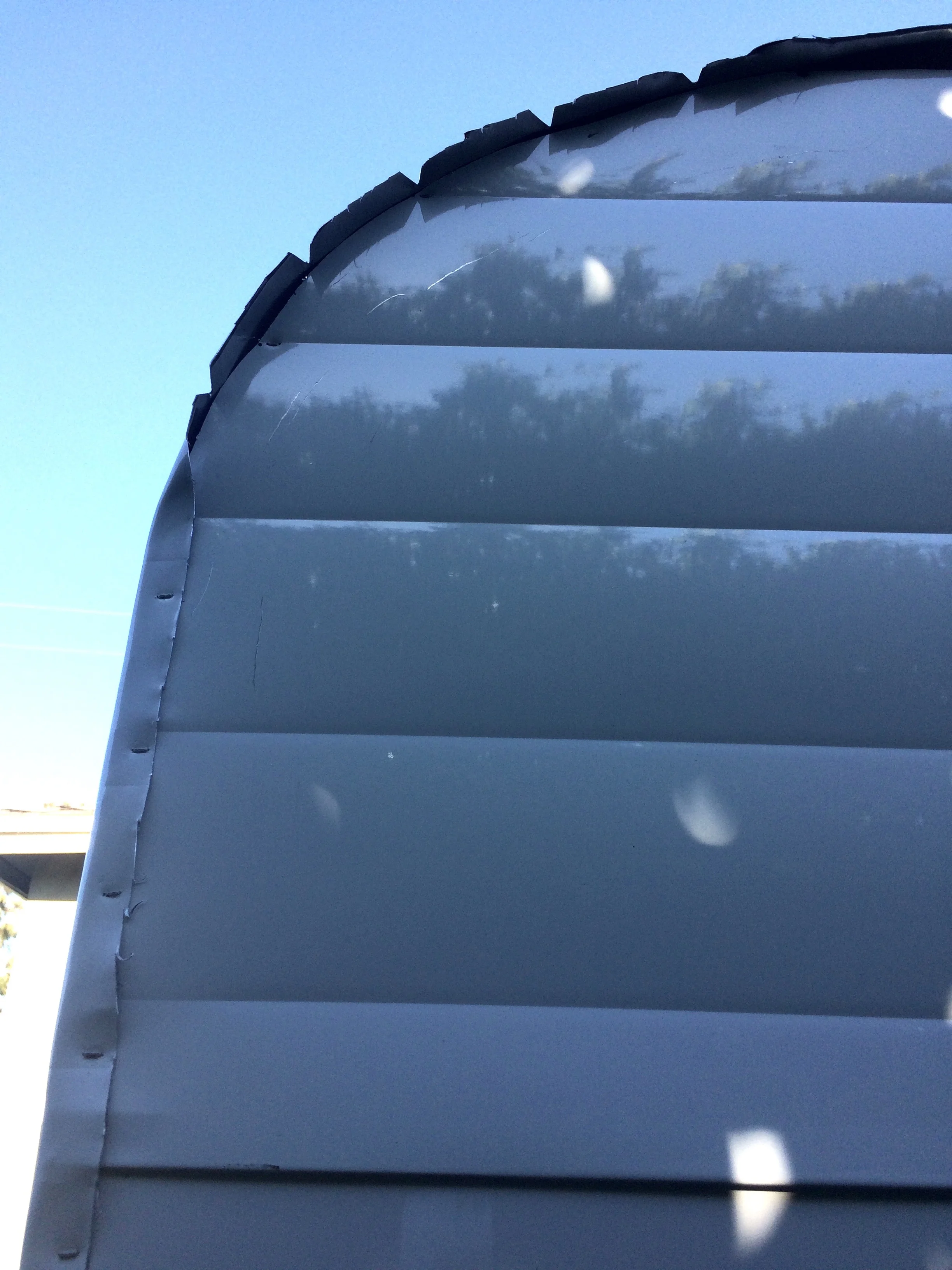 Folding the roof piece over the side. Notice the notches cut around the radius - this reduces any buckling of any excess material.