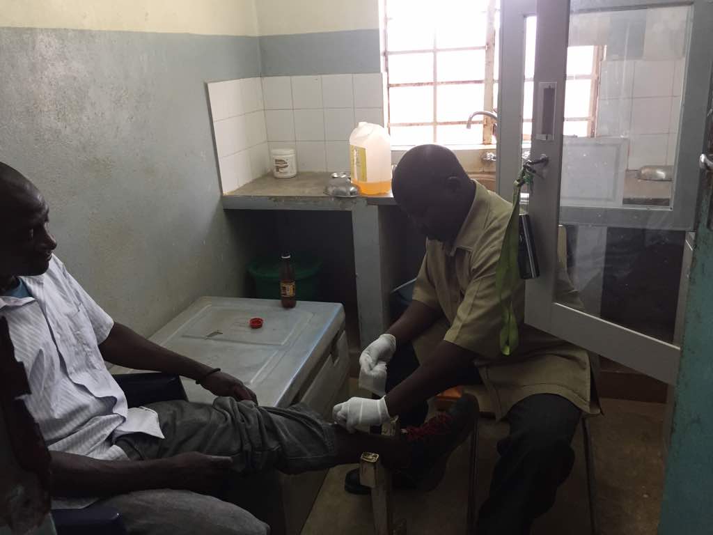 A Kabudula Community Hospital Clinician treating a patient in the current trauma room.