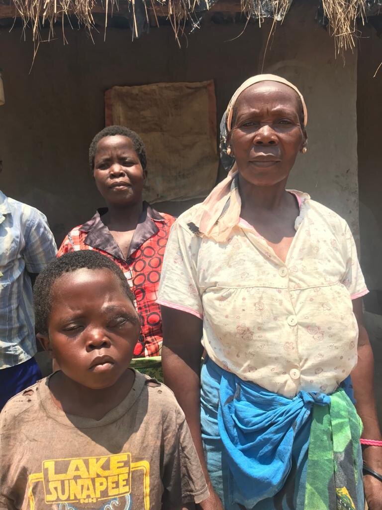  David and his extended family stand in front of their family home. 