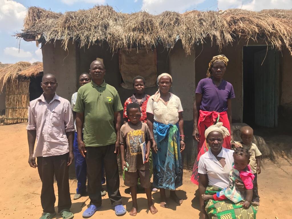  David and his extended family stand in front of their family home. 