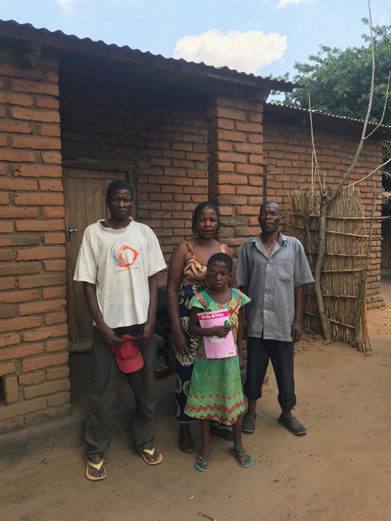  Coleta with her mother, father, and uncle in front of the family’s home. 