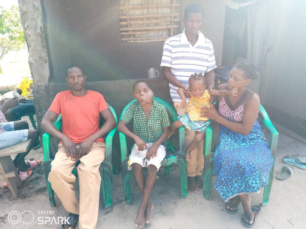 Mphatso with his father, Helder, and Helder's family