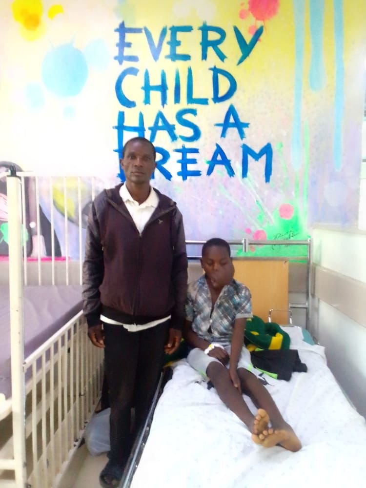 Mphatso with his father in Mercy James Institute in Blantyre.