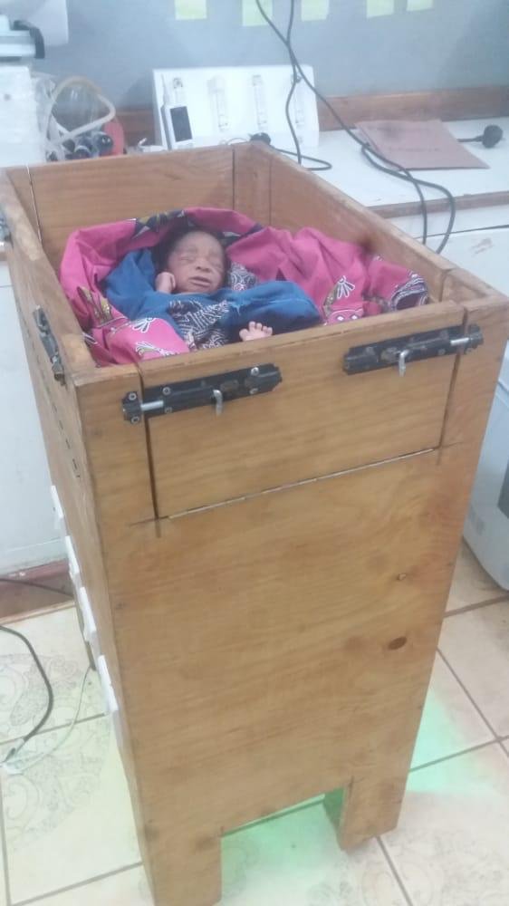  A newborn is placed in a neonatal warmer made by local craftspeople from local materials, commissioned by AHA in 2019. 