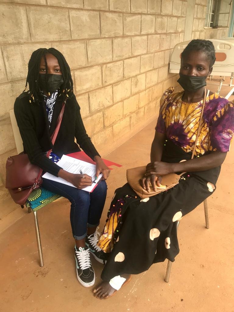 Christina's daughter, Psyela (left), conducts a patient interview.