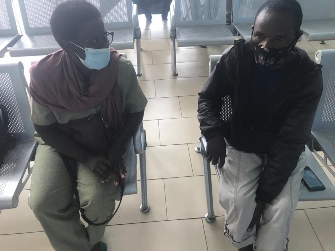 Christina talks with Alick, the father of Mphatso, a young patient with a sever facial tumor receiving medical sponsorship from AHA.