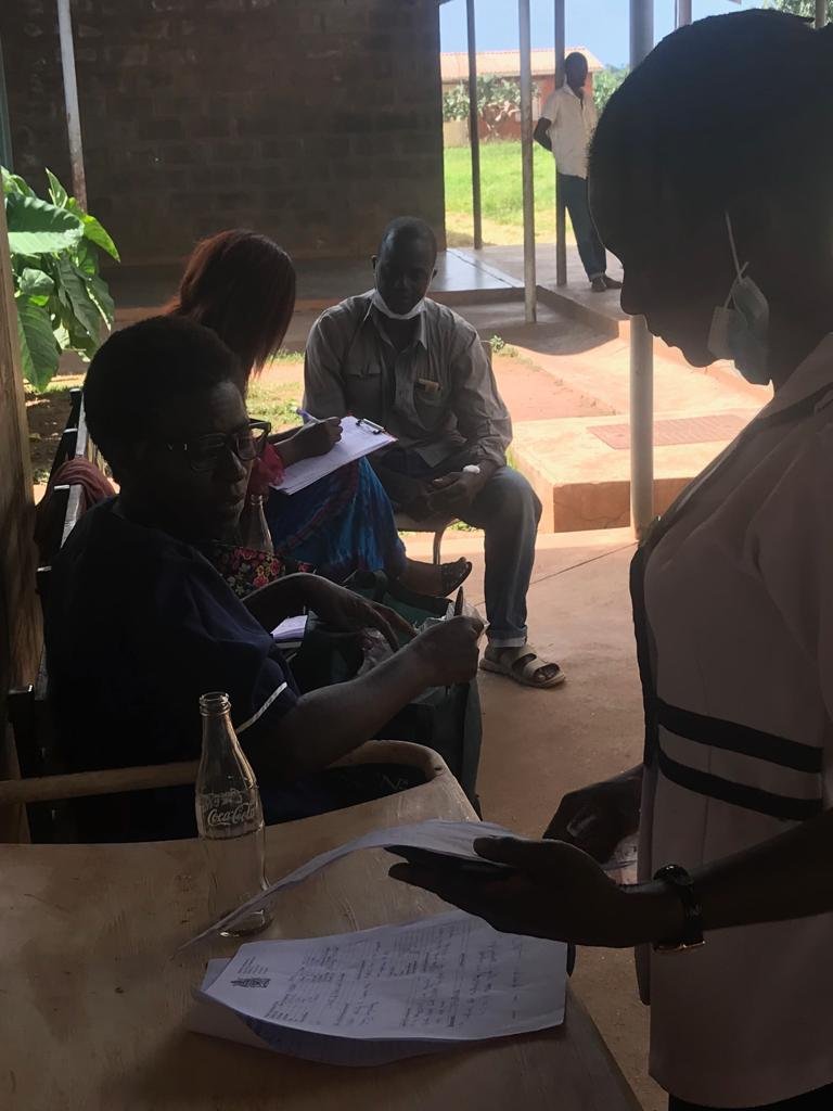 Christina (seated) discusses a patient cart with Kab's ward nurse.