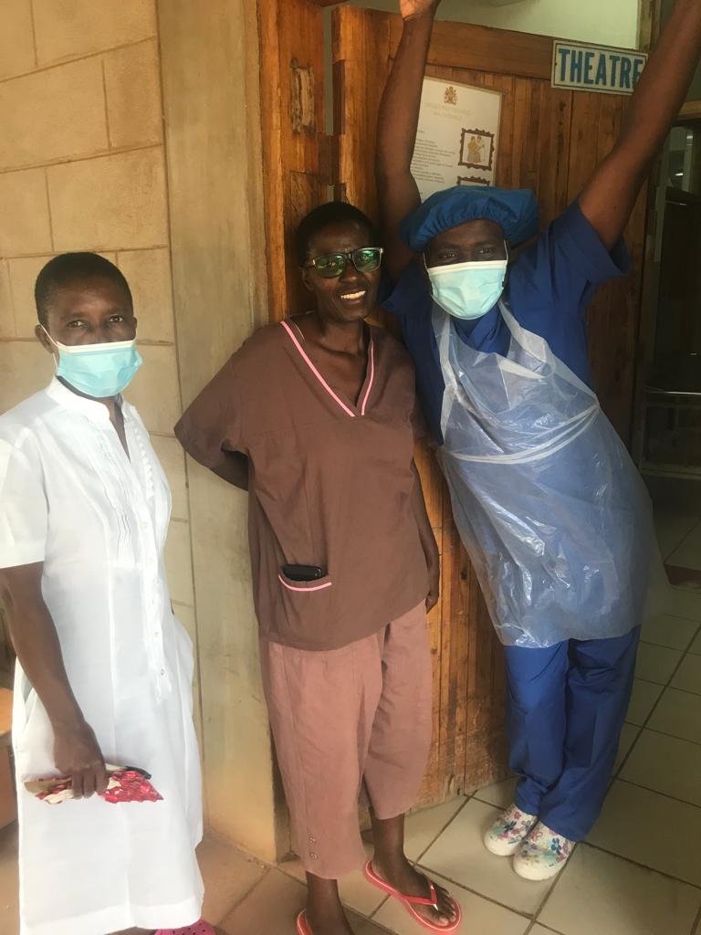 Christina (center) pauses with Kab's Ward Nurse Annie and KCH Mentoring Surgical Specialist Nelson mid-conversation for a silly snapshot.