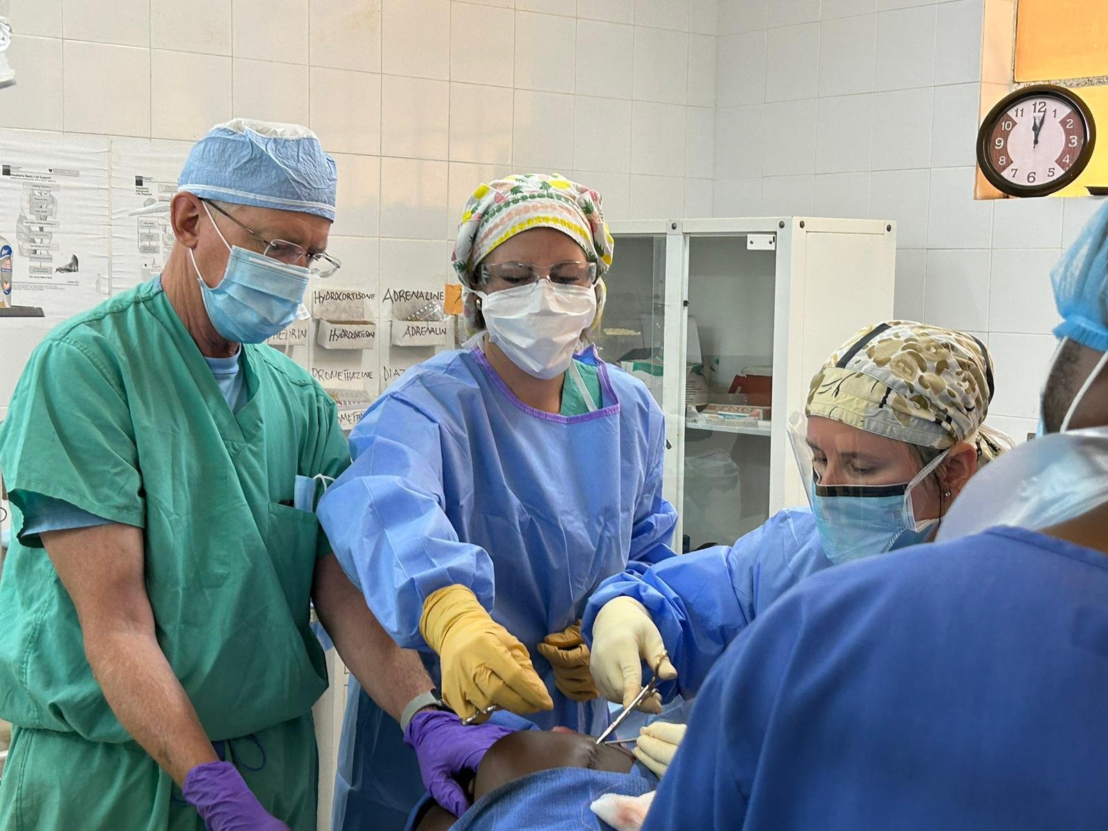 Ari, center, assists Dr. Roeder during a case.