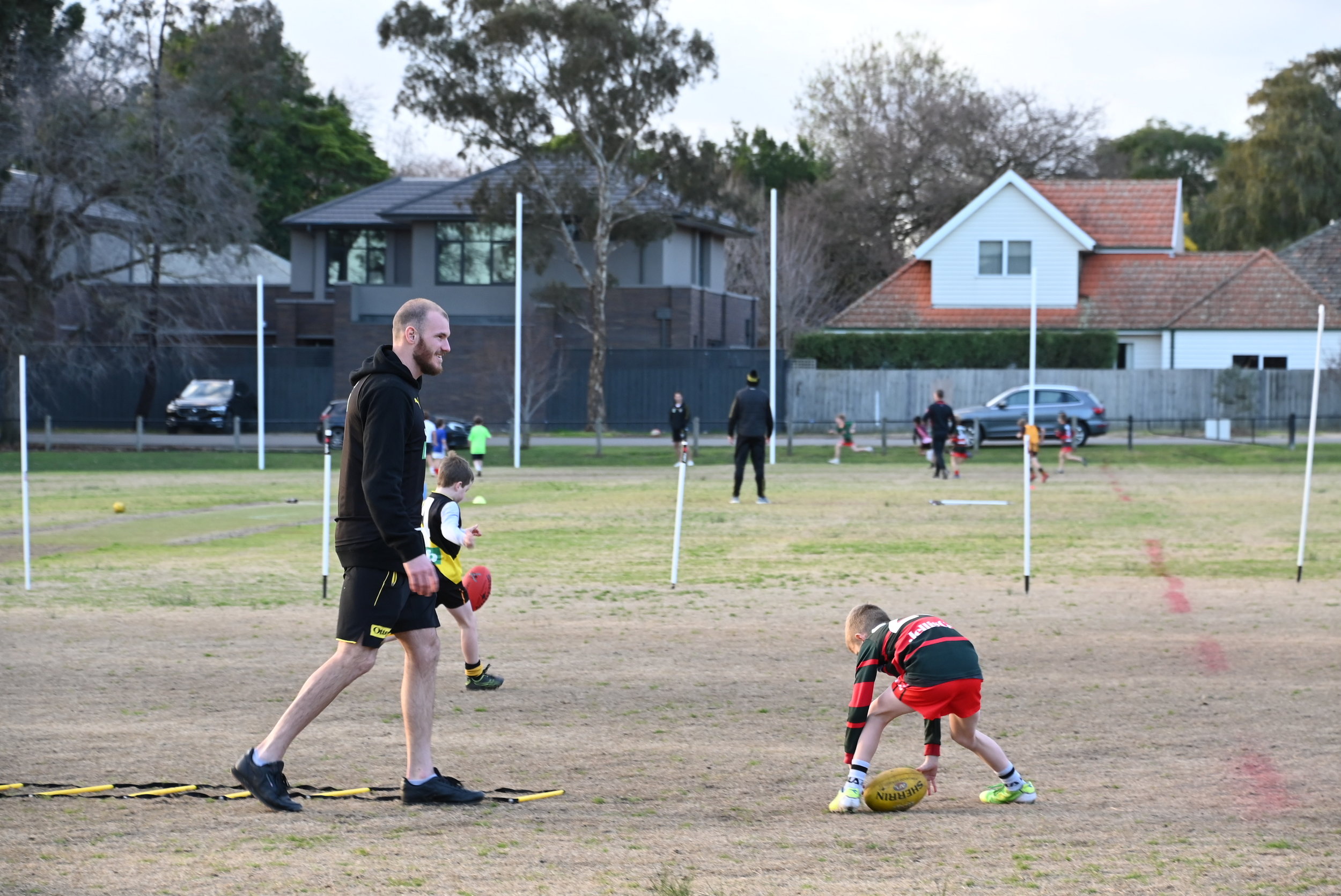 Kamdyn McIntosh from Richmond Football Club helps out U8 White at their weekly training session.