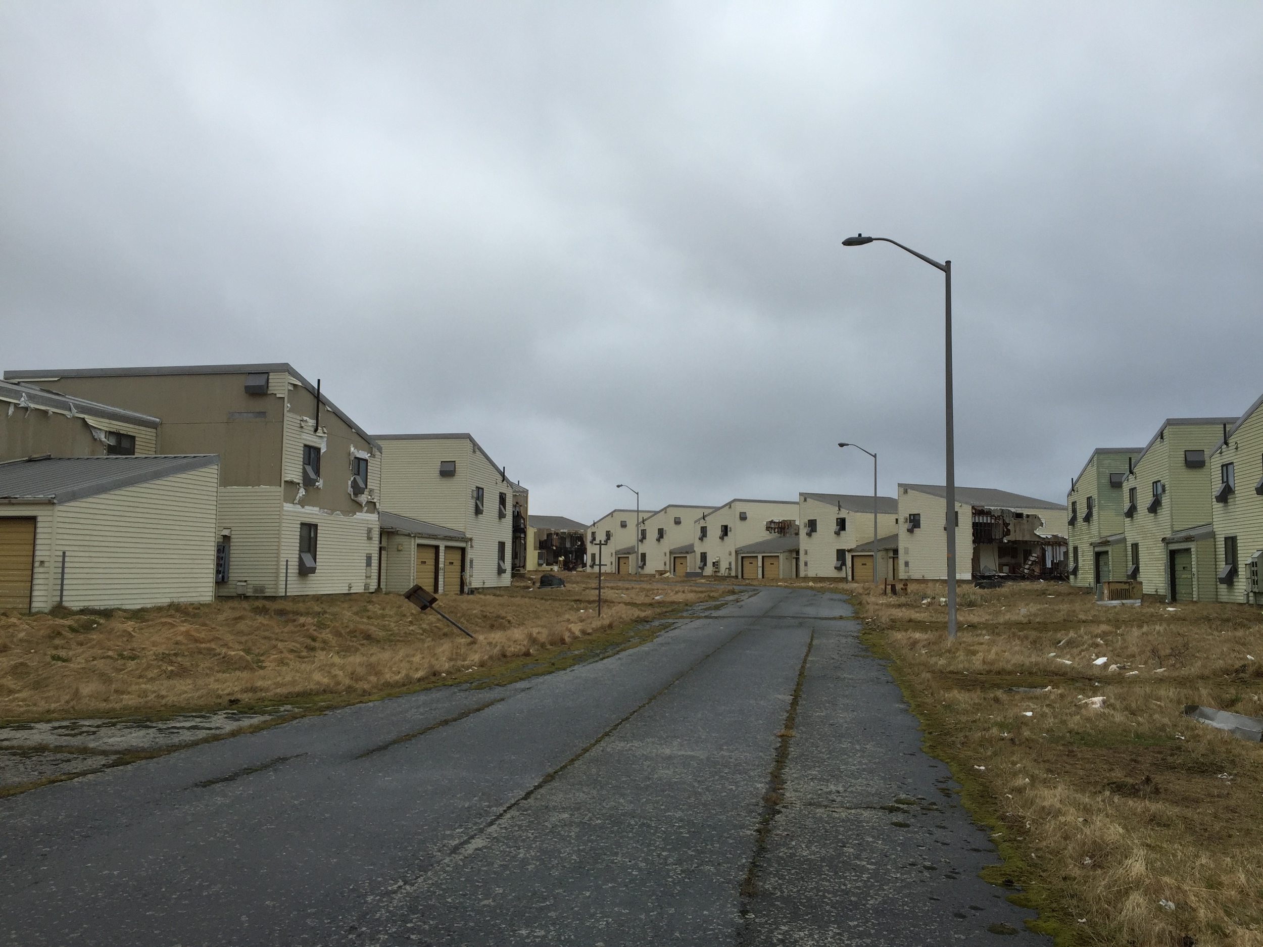 Abandoned houses ripped by winds slowly break down piece by piece, becoming part of the Adak landscape