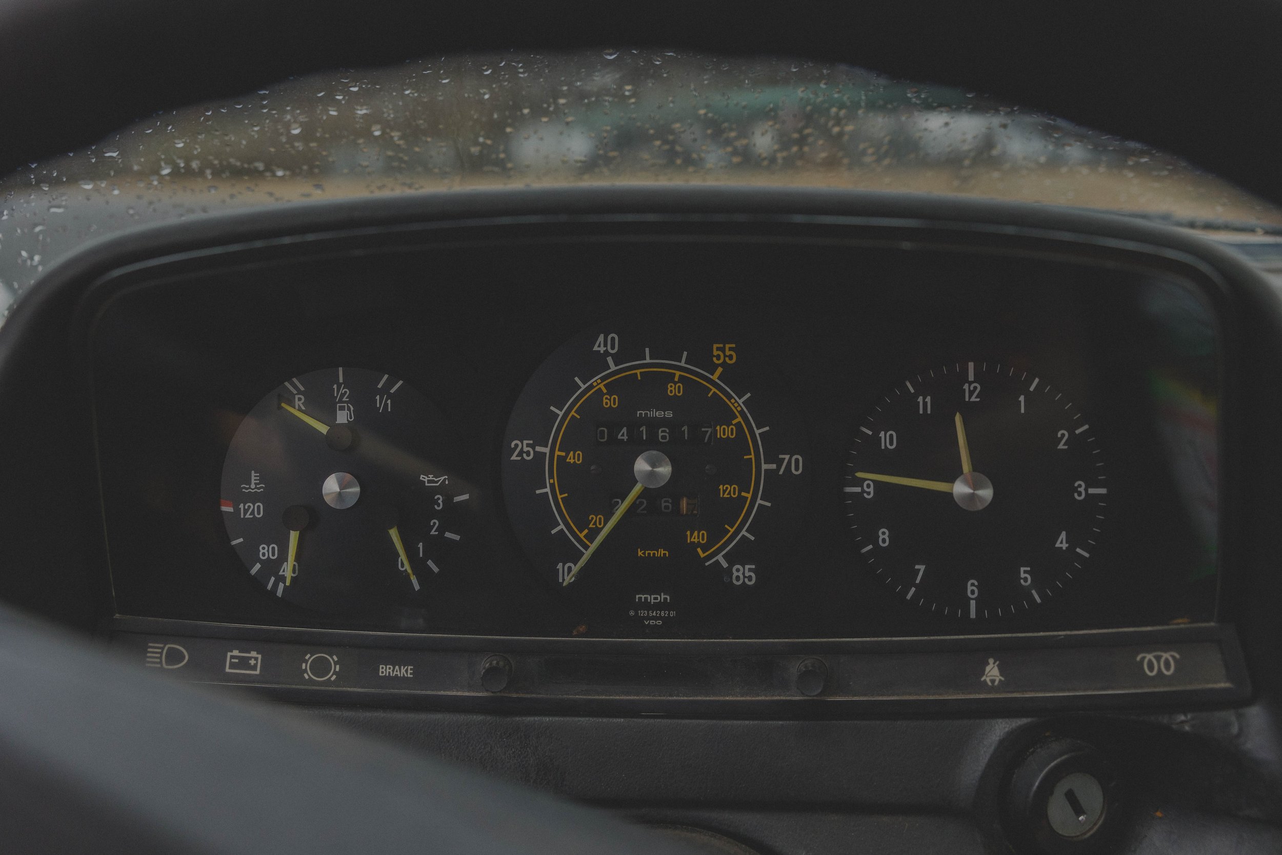 Vintage car dashboard showing speedometer, fuel gauge, and clock.